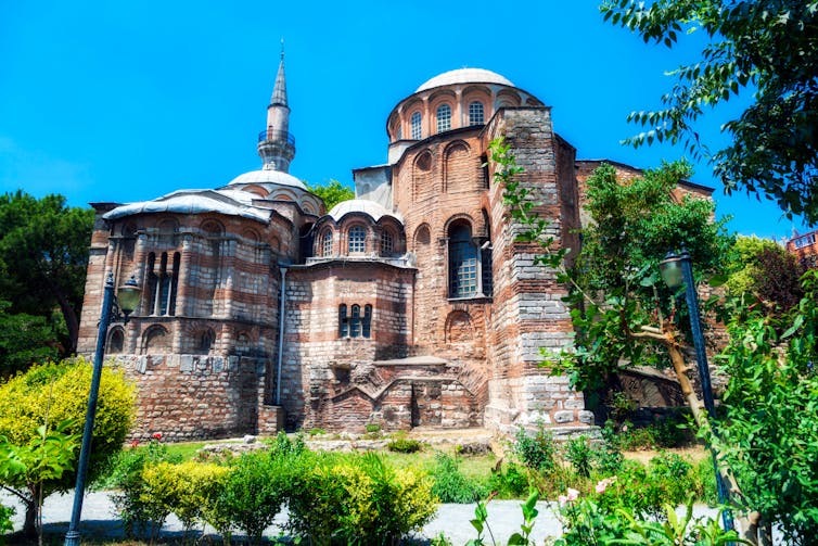Stone Byzantine church under blue sky.