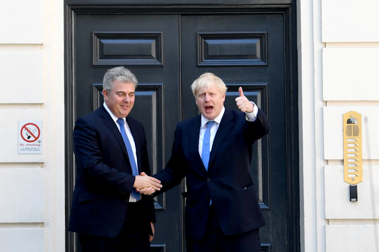 Brandon Lewis and Boris Johnson shaking hands.