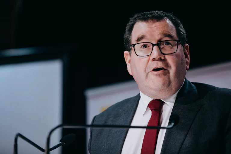 man in suit at microphone