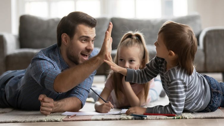 A father playing with his kids at home