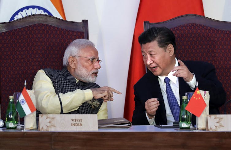 Indian leader Narendra Modi points finger during conversation with China's Xi Jinping.