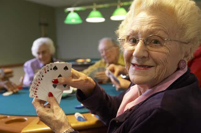 Group of older people playing bridge
