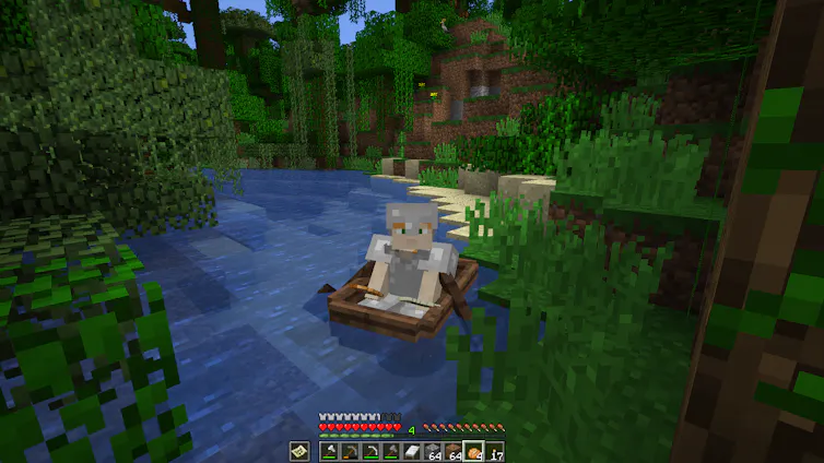 A minecraft character on a screen rowing a boat, surrounded by greenery