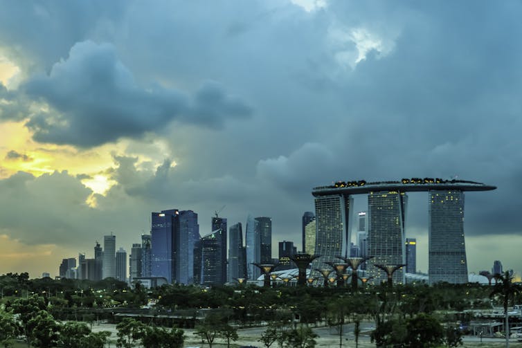 A Singapore skyline with clouds and some sun breaking through.