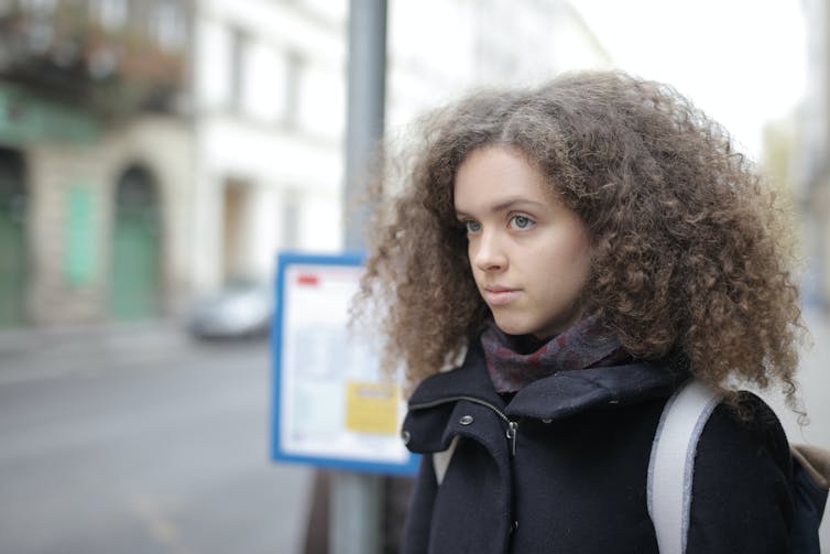 Girl waiting at bus stop