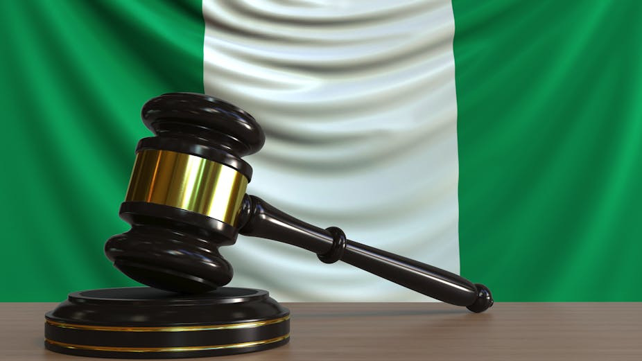 Judge's gavel and block against the flag of Nigeria