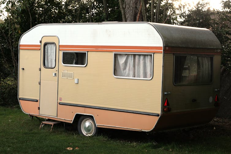 Beige and white caravan on some grass