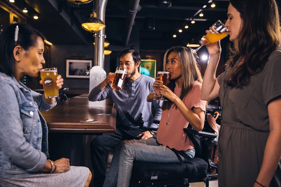 A group of four people drinking beer.