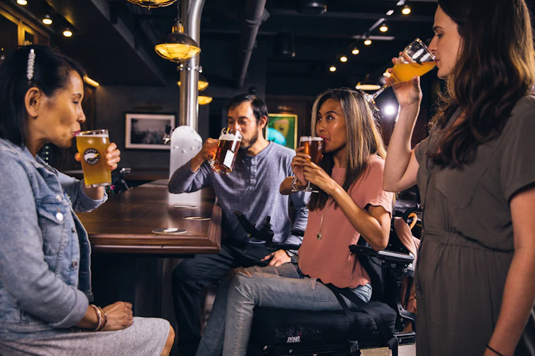 A group of four people drinking beer.
