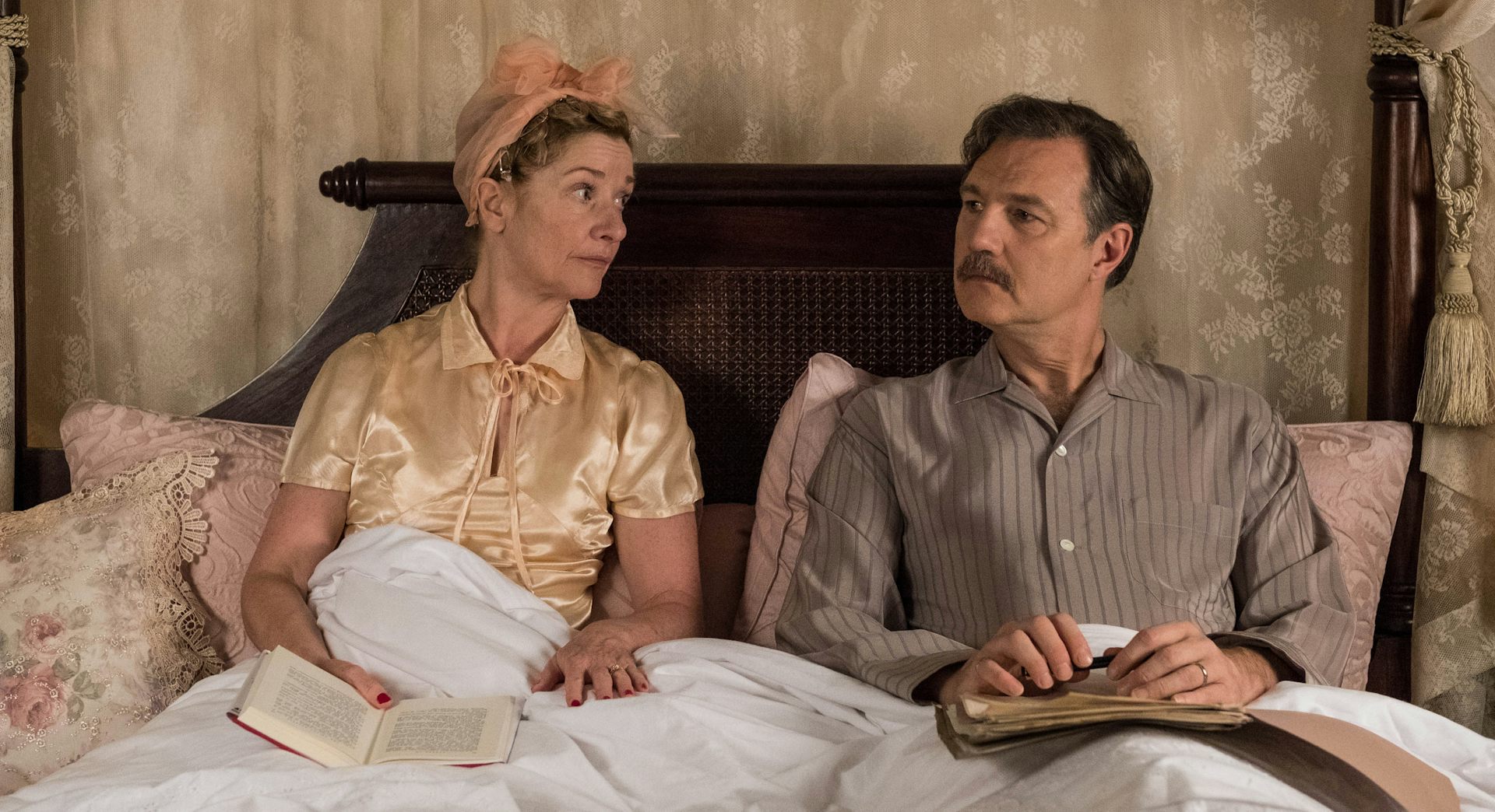 Man and woman in bed in pyjamas.