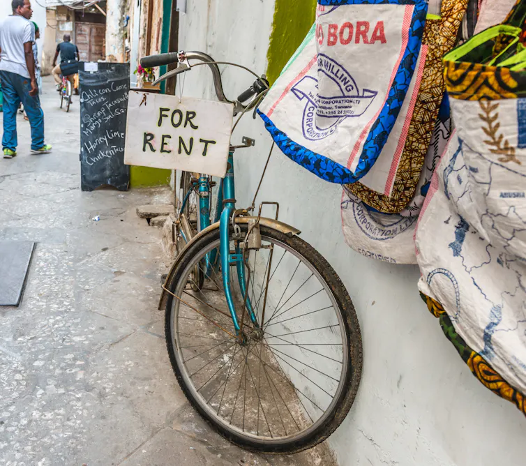 Bicycle for rent outside a shop.