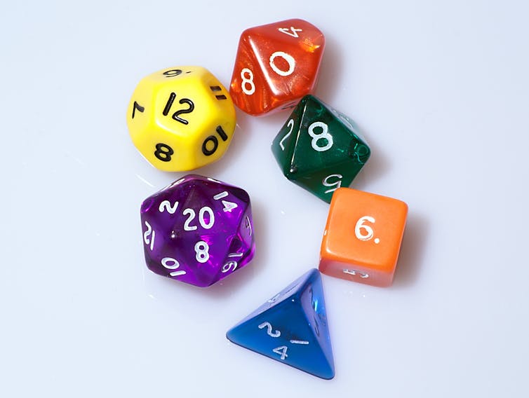 Dice with different numbers of sides of different colors.