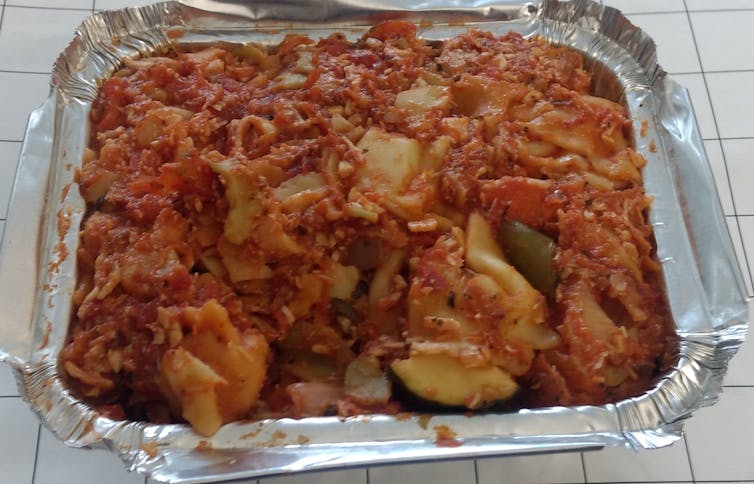 A picture of an entree in a disposable container.