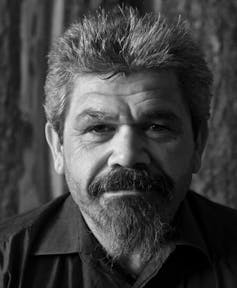 Black and white portrait of man with beard.