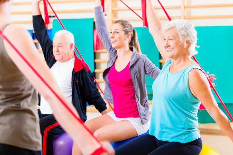 A group of people perform exercises with a resistance band.