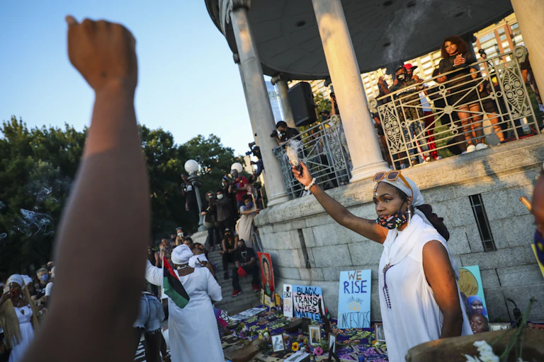 A woman burns sage at a Black Lives Matter protest.