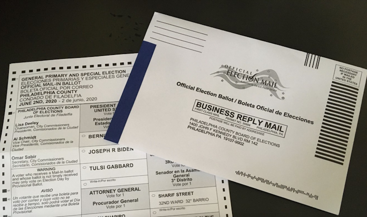 A mail-in election ballot partially obscured by its envelope