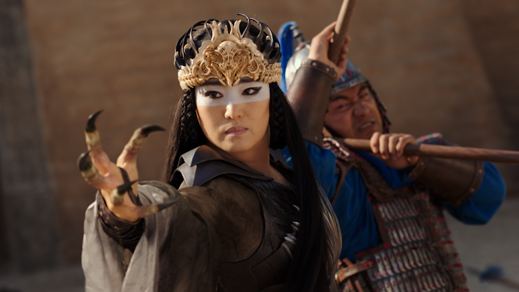 Xianniang reaches towards the camera with an eagle's claw for a hand.