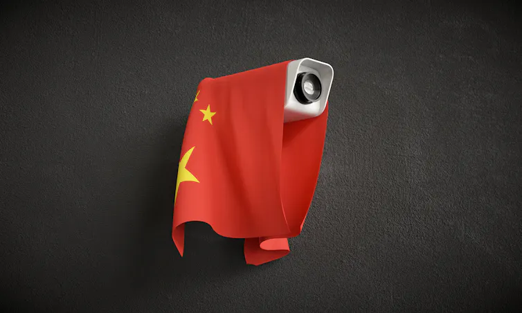 Illustration of surveillance camera with Chinese flag draped over.