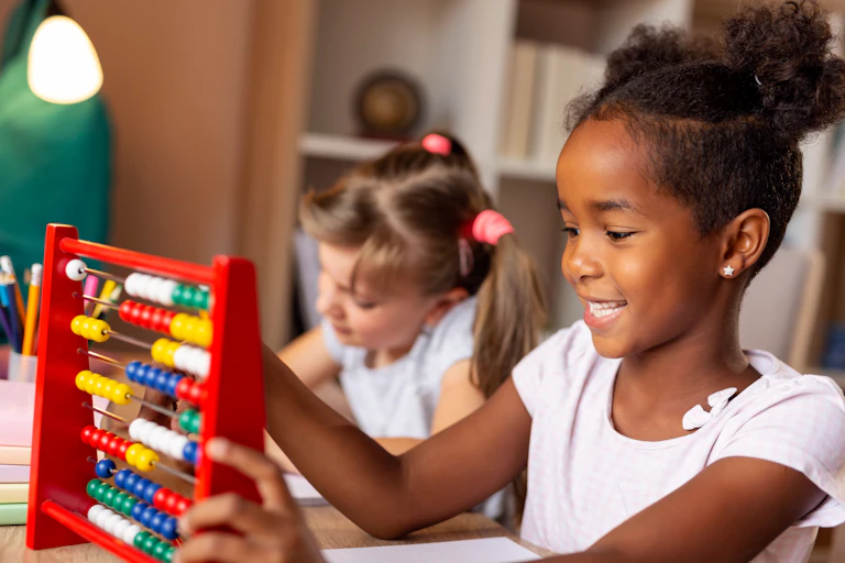 Young girl counting on an abacus