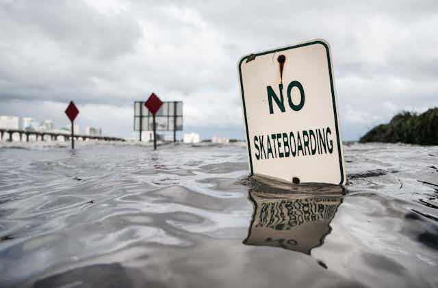 A 'no skateboarding' sign under water along the St. Johns River in Jacksonville, Florida, during Hurricane Irma.