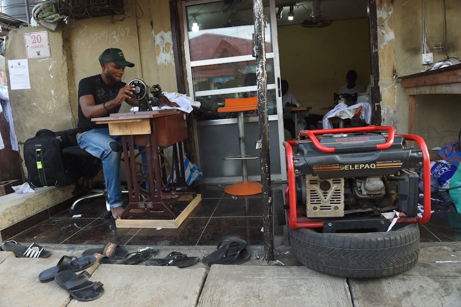 A tailor using a generator for power due to the epileptic public power supply in Lagos.  