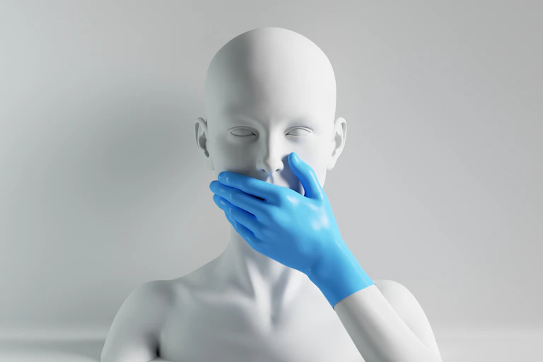 Cabeza de maniquí tapándose la boca con una mano enguantada.