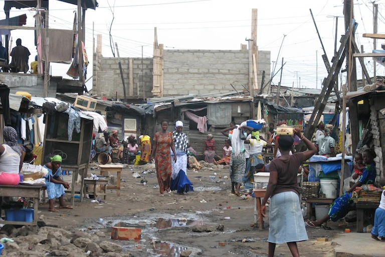 Traders and passersby go about their daily routine in Old Fadama