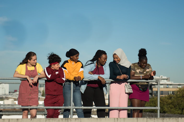 Group of girls look out on a city.