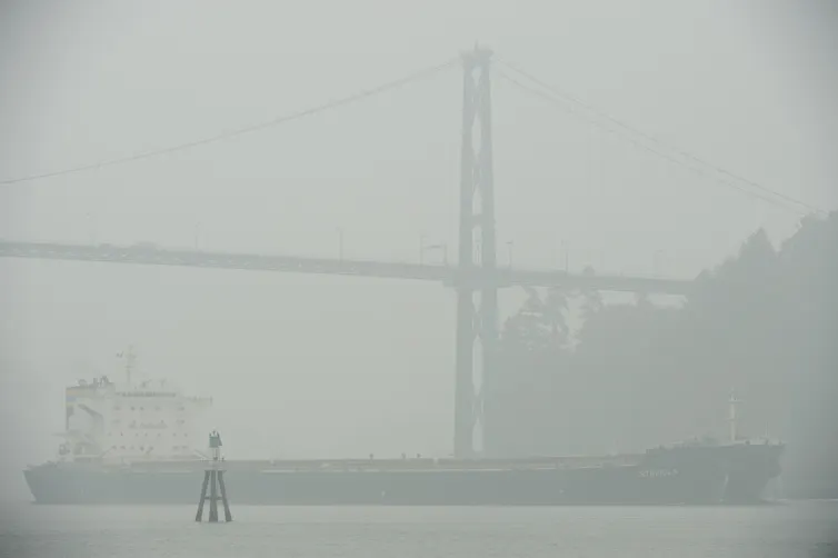 Thick smoke fills the air around a ship.