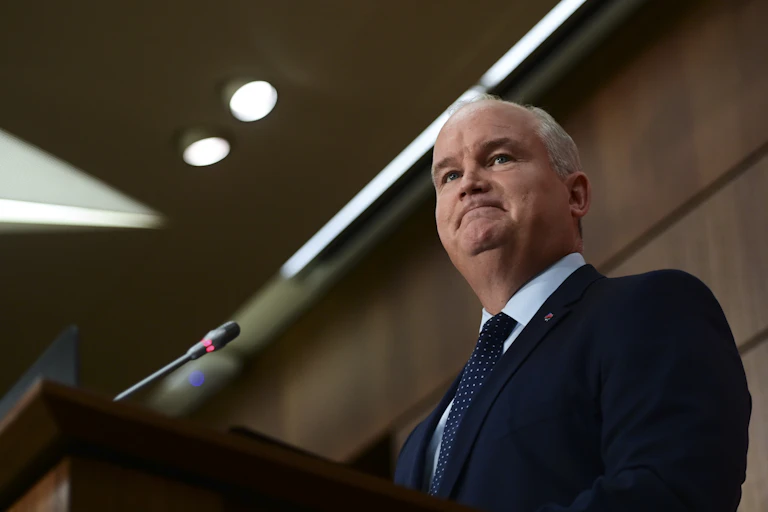 Erin O'Toole purses his lips at a news conference.
