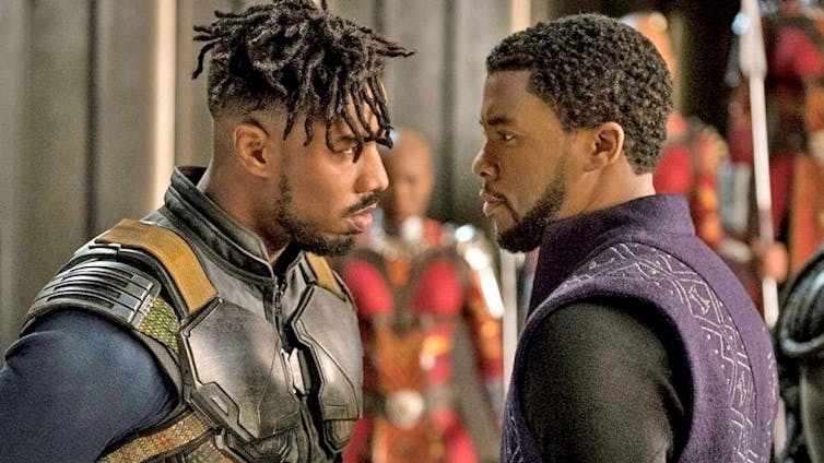 Characters Killmonger and Black Panther face each other.