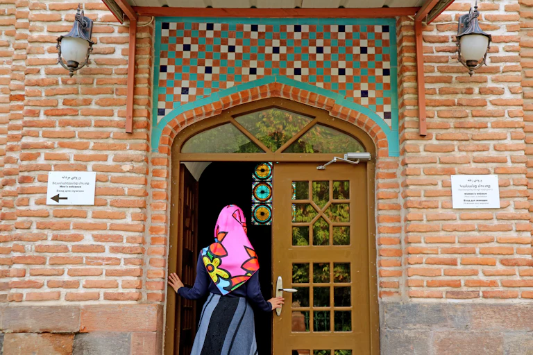 A woman enters a mosque.