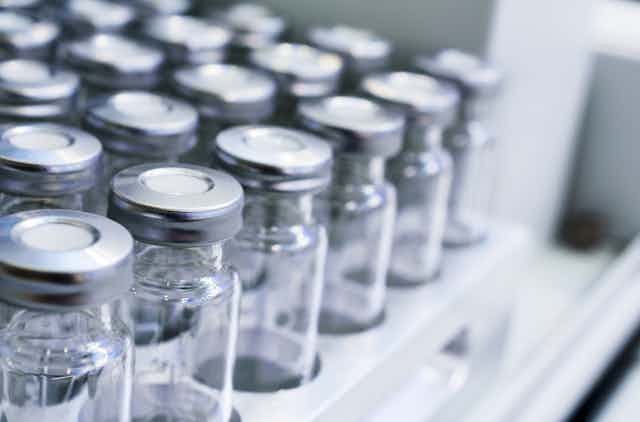 Group of empty vaccine bottles in a rack