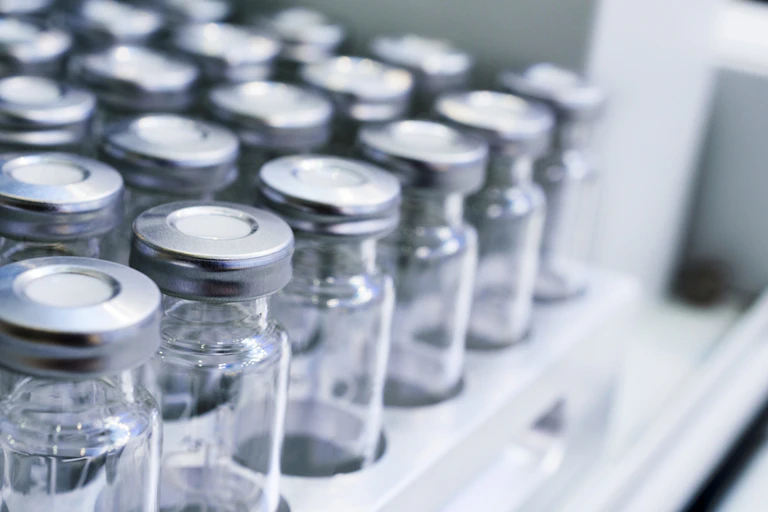 Group of empty vaccine bottles in a rack