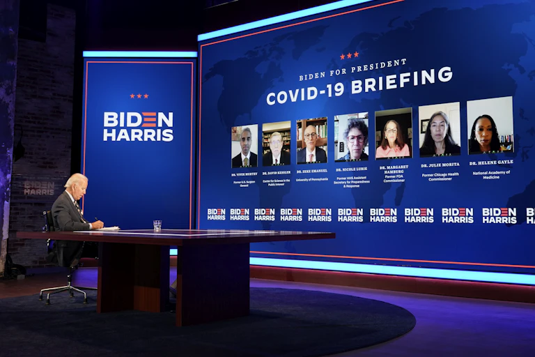US Democratic presidential candidate Joe Biden sitting on stage, heading a COVID-19 briefing