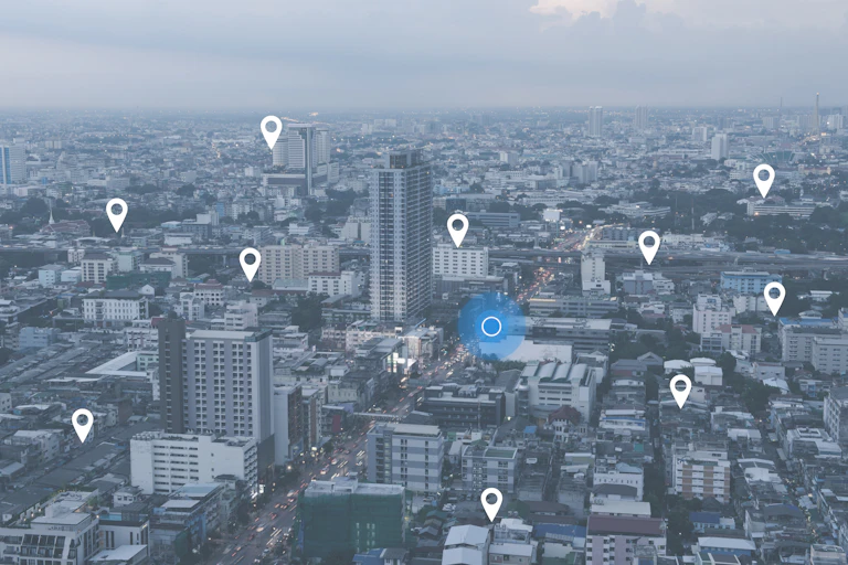 GPS pins dot a city landscape, indicating different locations