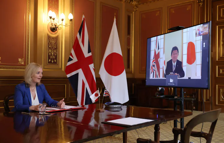 UK Trade Secretary Liz Truss in negotiations with Motegi Toshimitsu, the Japanese foreign minister.