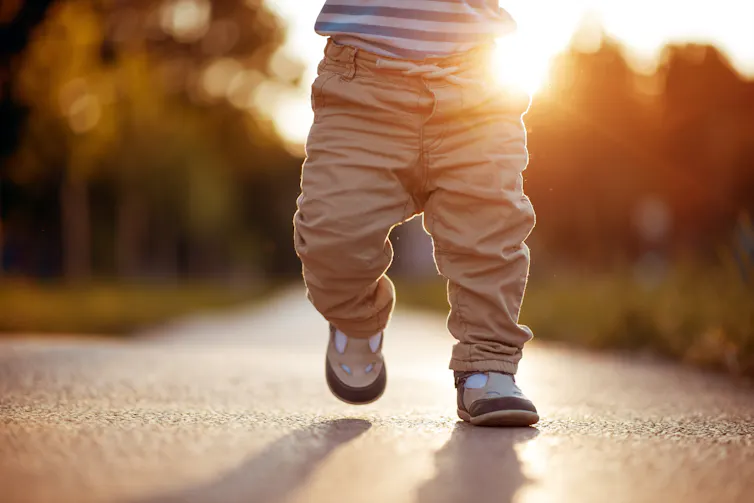 Toddler taking first steps.