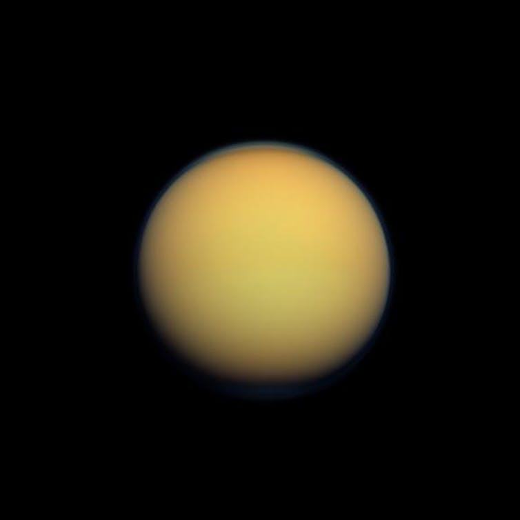 Yellow/orange moon Titan in space