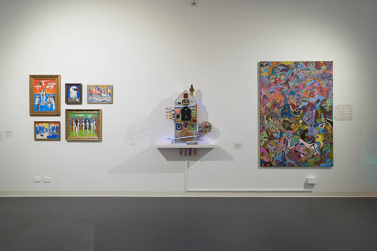 Three works of art on a gallery wall