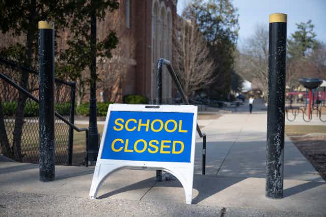 A closed sign outside a school.
