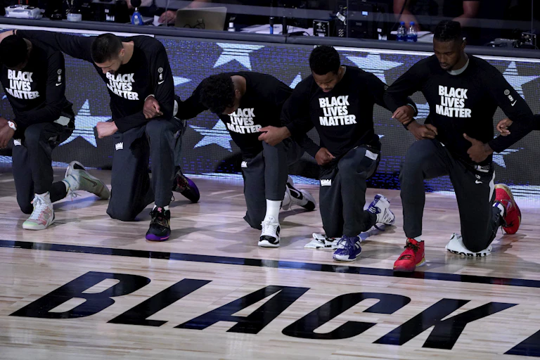 basketball players kneeling on court