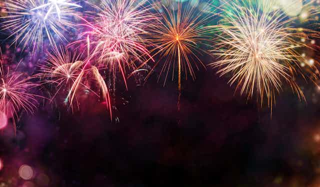 Multicoloured fireworks exploding in sky