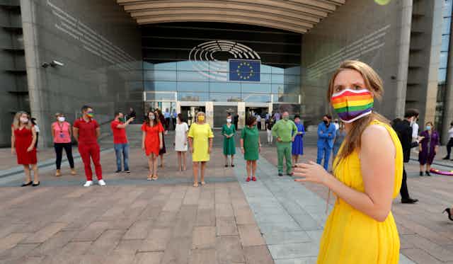 Members of the European Parliament dress in rainbow colours outside their building