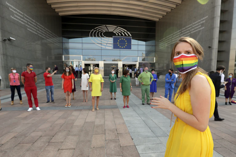 Members of the European Parliament dress in rainbow colours outside their building