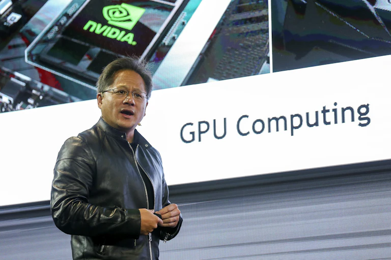 Nvidia CEO Jensen Huang stood in front of large screen.