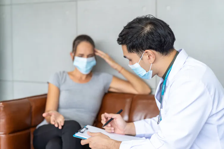 Woman speaking with doctor.