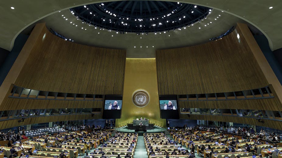 Rows of seats in front of a stage at the UN General Assembly hall. 