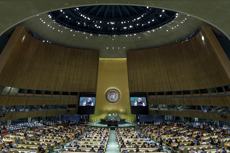 Rows of seats in front of a stage at the UN General Assembly hall.
